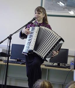 Donna Rhodenizer - plays accordion in school performance